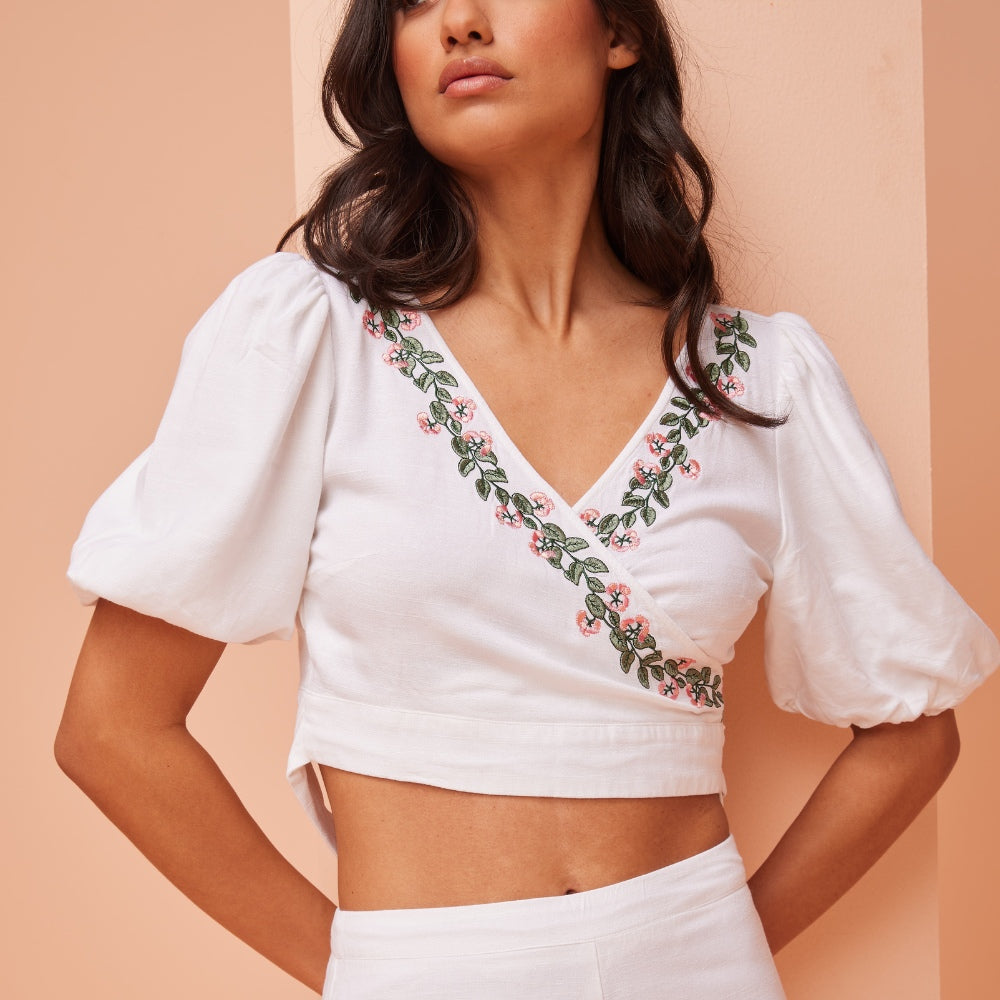 White Linen Sleeveless Top, Adorned with Elegant Leaf Embroidery Cascading from Shoulders.