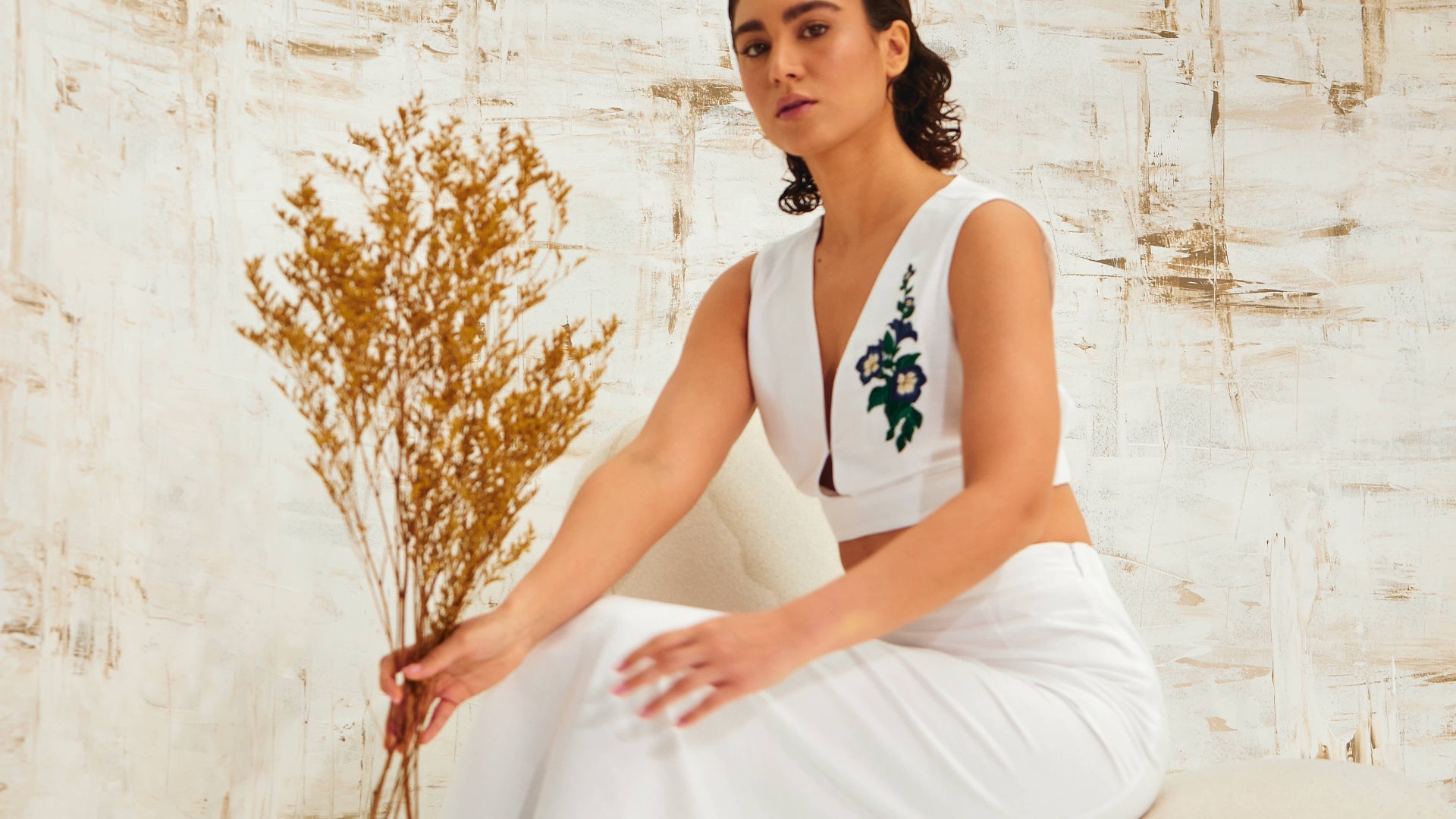 Model in Sleeveless Top Set, Adorned with Fresh Green Leaf Embroidery.